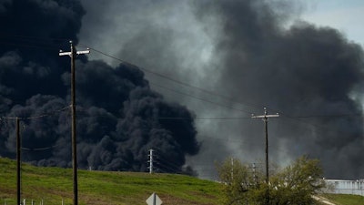 The petrochemical fire at Intercontinental Terminals Company reignited as crews tried to clean out the chemicals that remained in the tanks Friday, March 22, 2019, in Deer Park, Texas. The efforts to clean up a Texas industrial plant that burned for several days this week were hamstrung Friday by a briefly reignited fire and a breach that led to chemicals spilling into the nearby Houston Ship Channel.