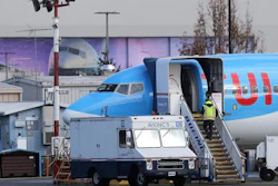 A worker walks up steps to the right of an avionics truck parked next to a Boeing 737 MAX 8 airplane being built for TUI Group at Boeing Co.'s Renton Assembly Plant Wednesday, March 13, 2019, in Renton, Wash. President Donald Trump says the U.S. is issuing an emergency order grounding all Boeing 737 Max 8 and Max 9 aircraft in the wake of a crash of an Ethiopian Airliner.