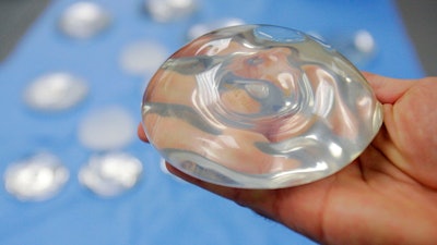 This Dec. 11, 2006 file photo shows a silicone gel breast implant in Irving, Texas. U.S. health officials are taking another look at the safety of breast implants, the latest review in a decades-long debate. At a two-day meeting that starts Monday, March 25, 2019, a panel of experts for the U.S. Food and Drug Administration will hear from researchers, plastic surgeons and implant makers, as well as from women who believe their ailments were caused by the implants.