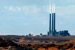 In this Sept. 4, 2011, file photo, smoke rises from the stacks of the main plant facility at the Navajo Generating Station, as seen from Lake Powell in Page, Ariz. The owners of one of the largest coal-fired power plants in the West say negotiations with a tribe to take over the plant have hit an impasse. A Navajo Nation energy company has been talking with owners of the Navajo Generating Station to buy the plant that's scheduled to shut down in December.