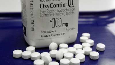 This Feb. 19, 2013, file photo shows OxyContin pills arranged for a photo at a pharmacy in Montpelier, Vt. Oklahoma's attorney general will announce a settlement Tuesday, March 26, 2019, with Purdue Pharma, one of the drug manufacturers named in a state lawsuit that accuses them of fueling the opioid epidemic.