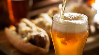Pouring Amber Beer Into Mug With Bratwursts In Background 843389516 3867x2579