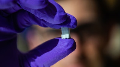 Rice University graduate student Sean Bittner holds a 3D-printed scaffold created to help heal osteochondral injuries. The initial study is a proof-of-concept to see if printed structures can mimic the gradual transition from smooth, compressible cartilage to hard bone at the end of long bones.
