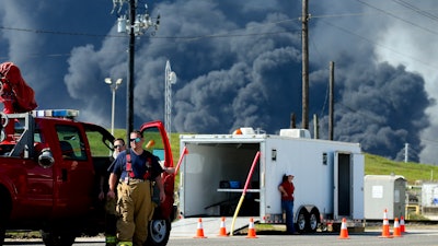 Firefighters arrive at the site where the Intercontinental Terminals Company petrochemical fire reignited, Friday, March 22, 2019, in Deer Park, Texas. The efforts to clean up a Texas industrial plant that burned for several days this week were hamstrung Friday by a briefly reignited fire and a breach that led to chemicals spilling into the nearby Houston Ship Channel.