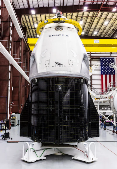 In this Dec. 18, 2018 photo provided by SpaceX, SpaceX's Crew Dragon spacecraft and Falcon 9 rocket are positioned inside the company's hangar at Launch Complex 39A at NASA's Kennedy Space Center in Florida, ahead of the Demo-1 unmanned flight test. SpaceX rockets closer to human spaceflight with this weekend’s debut of a new capsule designed for astronauts. The six-day test flight will be real in every regard, beginning with a Florida liftoff Saturday, March 2, 2019, and a docking the next day with the International Space Station. But the Dragon capsule won’t carry humans, rather a test dummy in the same white SpaceX spacesuit that astronauts will wear.