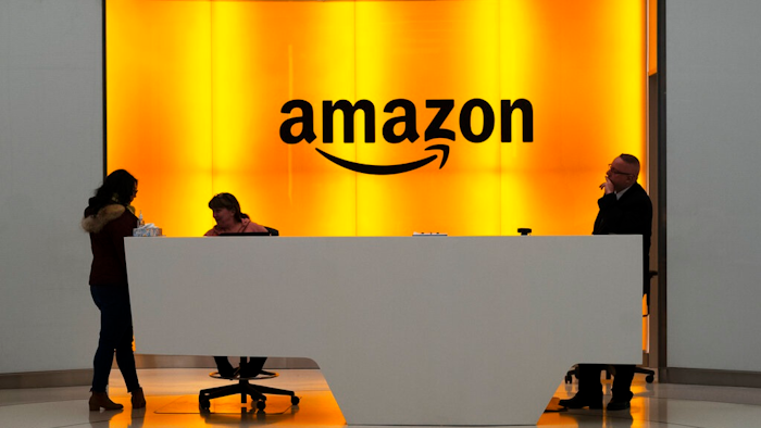 In this Feb. 14, 2019 file photo, people stand in the lobby for Amazon offices in New York. Amazon.com Inc. reports earns on Thursday, April 25.