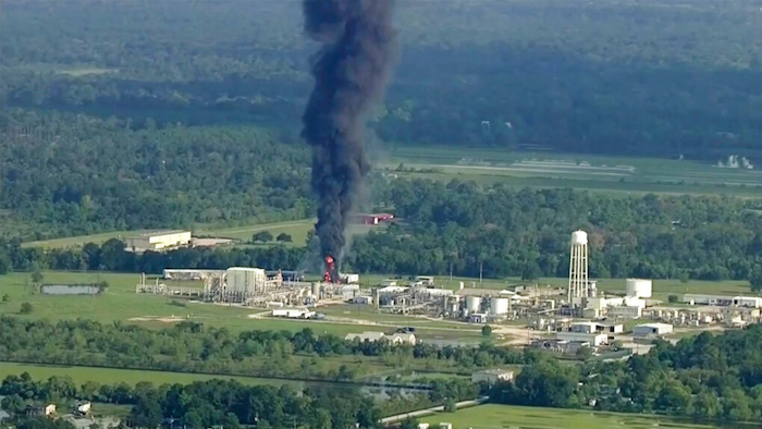 In this Sept., 2017 file photo, smoke rises from a chemical plant in Crosby, near Houston, Texas. The Harris County District Attorney's office announced Wednesday, April 10, 2019 that Arkema's vice president of logistics, Michael Keough, has been indicted for felony assault. Keough, is another senior employee of the chemical company now facing criminal charges connected to a 2017 explosion at Houston-area plant following Hurricane Harvey.