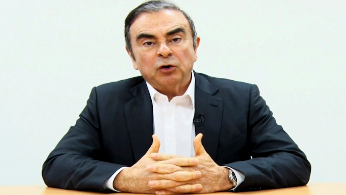 In this image made from a video released by Carlos Ghosn via his lawyer, the former Nissan chairman peaks on camera in Tokyo.