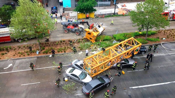 Fire and police crew members work to clear the scene where a construction crane fell from a building on Google's new Seattle campus crashing down onto one of the city's busiest streets and killing multiple people on Saturday, April 27, 2019.
