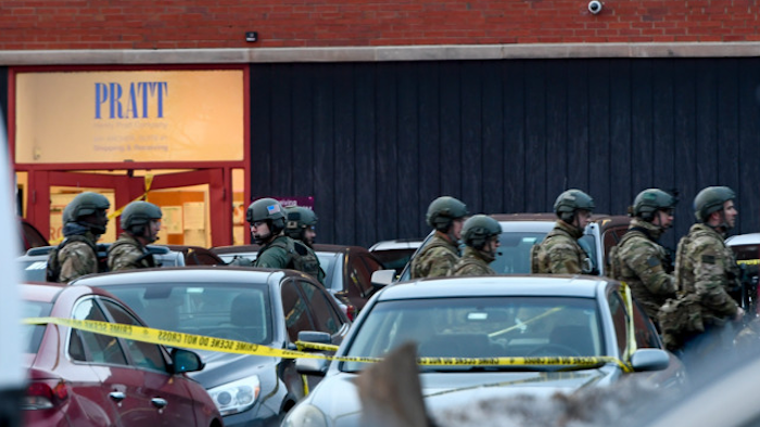 Law enforcement officers gather outside the Henry Pratt Co. manufacturing plant Friday, Feb. 15, 2019, in Aurora, Ill. Police say a gunman killed several people and injured police officers before he was fatally shot.