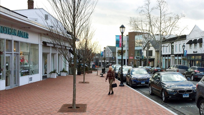 In this Jan. 26, 2017, file photo, a woman walks near shops in downtown Westport, Conn. The boom market in small businesses is showing signs of cooling. The number of small business sales counted by online market BizBuySell.com fell 6.5% during the first quarter from the same period of 2018, following a 6% fourth quarter drop.