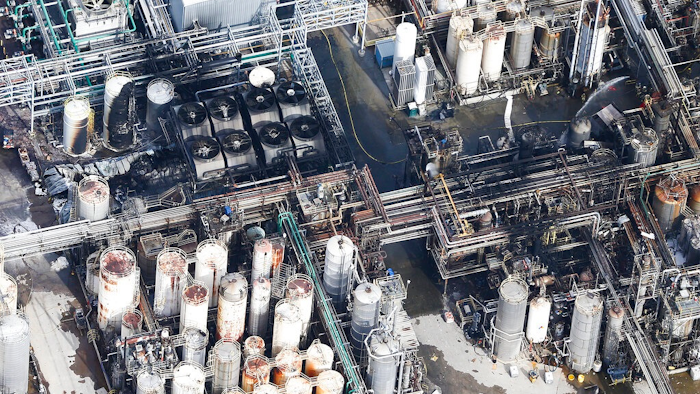 This aerial photo shows firefighters spraying water on a fire at the KMCO chemical plant on Tuesday, April 2, 2019 in Crosby, Texas. Authorities say the fire has been contained at the plant near Houston and they have lifted an order that instructed residents within a 1-mile (1.6 kilometers) radius of the facility to stay indoors.