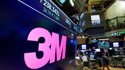 In this Oct. 24, 2017, file photo, the logo for 3M appears on a screen above the trading floor of the New York Stock Exchange. 3M plans to cut 2,000 globally as part of a restructuring due to a slower-than-expected 2019. The maker of Post-it notes, industrial coatings and ceramics said Thursday that the move is expected to save about $225 million to $250 million a year.