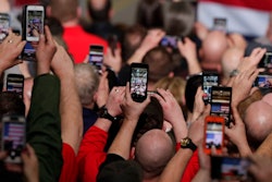 In this March 20, 2019, photo workers take photos with their phones as President Donald Trump speaks at Joint Systems Manufacturing Center in Lima, Ohio. Congress is starting to show interest in prying open the “black box” of tech companies’ artificial intelligence much the same way the federal government checks under car hoods and audits banks. President Donald Trump’s administration is also taking notice and has made the development of “trustworthy” algorithms a part of the White House’s new AI initiative.