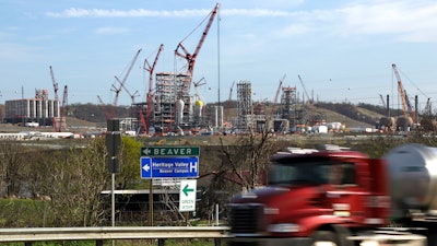 In this April 18, 2019 file photo a tanker truck passes a petrochemical plant being built on the banks of the Ohio River in Monaca, Pa., for the Royal Dutch Shell company. The plant, which is capable of producing 1.6 million tons of raw plastic annually, is expected to begin operations by 2021.