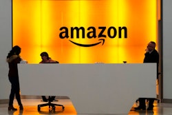 In this Feb. 14, 2019 file photo, people stand in the lobby for Amazon offices in New York. Amazon.com Inc. reports earns on Thursday, April 25.