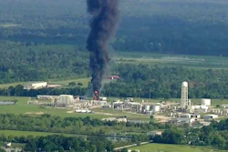In this Sept., 2017 file photo, smoke rises from a chemical plant in Crosby, near Houston, Texas. The Harris County District Attorney's office announced Wednesday, April 10, 2019 that Arkema's vice president of logistics, Michael Keough, has been indicted for felony assault. Keough, is another senior employee of the chemical company now facing criminal charges connected to a 2017 explosion at Houston-area plant following Hurricane Harvey.