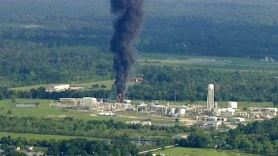 In this Sept., 2017 file photo, smoke rises from a chemical plant in Crosby, near Houston, Texas. The Harris County District Attorney's office announced Wednesday, April 10, 2019 that Arkema's vice president of logistics, Michael Keough, has been indicted for felony assault. Keough, is another senior employee of the chemical company now facing criminal charges connected to a 2017 explosion at Houston-area plant following Hurricane Harvey.