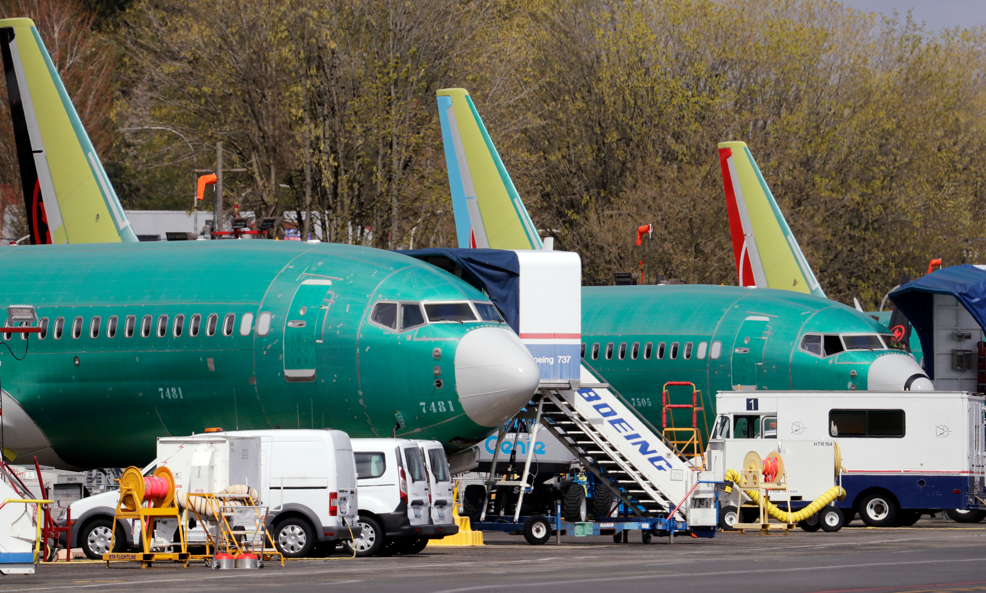 In this file photo Boeing 737 Max 8 jets, built for American Airlines, left, and Air Canada are parked at the airport adjacent to a Boeing production facility in Renton, Washington.