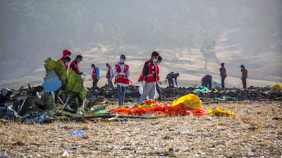 In this March 11, 2019, file photo rescuers work at the scene of an Ethiopian Airlines flight crash near Bishoftu, or Debre Zeit, south of Addis Ababa, Ethiopia. Investigators have determined that an anti-stall system automatically activated before the Ethiopian Airlines Boeing 737 Max jet plunged into the ground, The Wall Street Journal reported Friday, March 29.