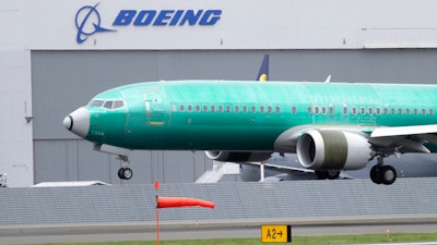 In this April 10, 2019, file photo a Boeing 737 MAX 8 airplane being built for India-based Jet Airways lands following a test flight at Boeing Field in Seattle. Boeing Co. reports earnings Wednesday, April 24.