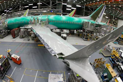 In this March 27, 2019, file photo taken with a fish-eye lens, a Boeing 737 MAX 8 airplane sits on the assembly line during a brief media tour in Boeing's 737 assembly facility in Renton, Wash. Boeing is cutting production of its grounded Max airliner this month to focus on fixing flight-control software and getting the planes back in the air. The company said Friday, April 5, that starting in mid-April it will cut production of the 737 Max from 52 to 42 planes per month.