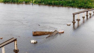 This photo shows a ferry boat which collided with a bridge pillar causing part of the bridge to collapse in the Moju river, in the Brazilian state of Para.