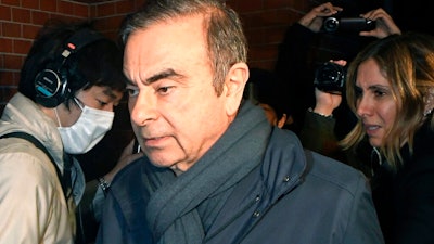 In this April 3, 2019, file photo, former Nissan Chairman Carlos Ghosn, center, returns to his residence in Tokyo. Japanese court approves release for detained Nissan ex-chair Ghosn on 500 million yen, or $4.5 million, bail.