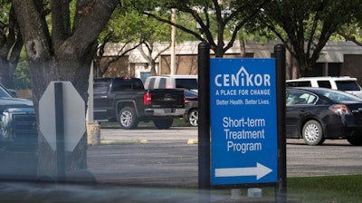 In this April 18, 2019 photo, a sign to the Cenikor Foundation entrance is seen in Deer Park, Texas. The nationally renowned drug rehab program in Texas and Louisiana has sent patients struggling with addiction to work for free for some of the biggest companies in America, likely in violation of federal labor law. Reveal from The Center for Investigative Reporting has found that the Cenikor Foundation has dispatched tens of thousands of patients to work without pay at more than 300 companies over the years in the name of rehabilitation. Experts say Cenikor's business model might be illegal.