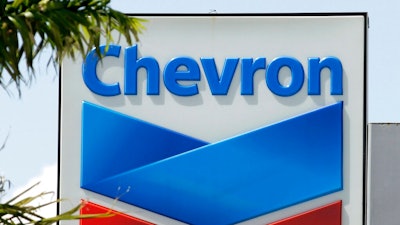 This Aug. 20, 2012, file photo, shows a Chevron sign in Miami. A Northern California jury ordered Chevron Corp. to pay the families of two brothers a combined $21.4 million after they claimed the men's exposure to a toxic chemical while working at a company plant caused the cancer that killed them. The San Francisco Chronicle reported that The Contra Costa County jury's verdict Friday, March 29, 2019. Brothers Gary Eaves and Randy Eaves worked at a Chevron-owned tire manufacturer in Arkansas.