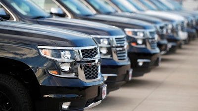 This June 24, 2018, photo shows unsold 2018 Suburbans at a Chevrolet dealership in Englewood, Colo. Automobile sales in the U.S. fell 2% in the first quarter, another sign the nation's economy is starting to slow.