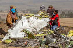 In this March 11, 2019, file photo, rescuers work at the scene of an Ethiopian Airlines flight crash near Bishoftu, Ethiopia. A published report says pilots of an Ethiopian airliner that crashed followed Boeing’s emergency steps for dealing with a sudden nose-down turn but couldn’t regain control.