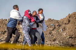 In this Wednesday March 13, 2019 file photo, a grieving relative who lost his wife in the plane crash is helped by a member of security forces and others near Bishoftu, in Ethiopia, at the scene where the Ethiopian Airlines jet crashed just after taking off from Addis Ababa on March 10, killing all 157 on board. A preliminary report finds that the crew of the Ethiopian Airlines jet that crashed last month performed all the procedures recommended by Boeing but could not control the plane.
