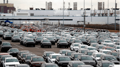 In this Feb. 26, 2019 file photo, Jeep vehicles are parked outside the Jefferson North Assembly Plant in Detroit. When Fiat Chrysler began considering where to build its next assembly plant, the automaker didn't have far to look for land. A short walk from its Jefferson North plant on Detroit's east side is 200 acres of land the company is eyeing as part of its $1.6 billion investment to convert an engine complex into a new facility. Decades of residential flight, disinvestment and abandonment have left the Motor City with stretches of available real estate which are appealing to some developers.