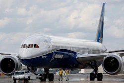 In this file photo Boeing employees walk the new Boeing 787-10 Dreamliner down towards the delivery ramp area at the company's facility in South Carolina. Singapore Airlines says it has grounded two of its Boeing 787-10 aircraft due to engine issues.