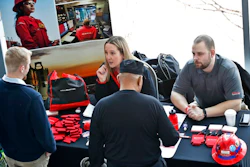 In this March 7, 2019, file photo visitors to the Pittsburgh veterans job fair meet with recruiters at Heinz Field in Pittsburgh.