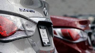 In this Oct. 4, 2012, file photo a Hyundai Sonata is displayed at a Hyundai car dealership in Des Plaines, Ill. The U.S. government’s highway safety agency said Monday, April 1, 2019, that it has decided to open two new investigations into fires involving Hyundai and Kia vehicles. The investigations cover non-crash fires in almost 3 million vehicles from the affiliated Korean automakers. The probes cover the 2011 through 2014 Hyundai Sonata and Santa Fe, the 2011 through 2014 Kia Optima and Sorento, and the 2010 through 2015 Kia Soul.