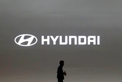 In this March 28, 2019, file photo a journalist passes by the logo of Hyundai Motor during a media preview of the Seoul Motor Show in Goyang, South Korea. Hyundai has found a new problem that can cause its car engines to fail or catch fire, issuing yet another recall to fix problems that have affected more than 6 million vehicles since 2015.