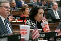 In this Feb. 20, 2019 file photo, state Rep. Anne Dauphinais R-Killingly, takes a sip from a big gulp soda as Connecticut Democrat Gov. Ned Lamont delivers his budget address at the State Capitol in Hartford, Conn. Lamont proposed a tax on sugary drinks in his first budget. Connecticut is among several states likely to see debate this year over taxes that advocates endorse as way to reduce consumption of liquid calories. On March 25 the American Academy of Pediatrics and the American Heart Association called for education campaigns and raising prices through taxes to reduce consumption of sugary drinks by young people.
