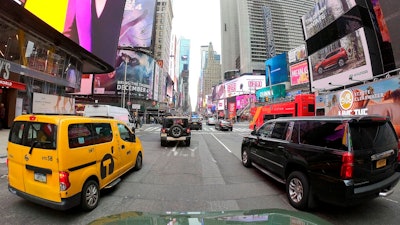 Motorists roll south on 7th Avenue in Times Square, Friday, March 29, 2019, in New York. A congestion toll that would charge drivers to enter New York City's central business district is a first for an American city. State legislators included it in the New York state budget that was approved Monday.