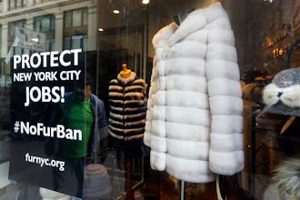 This April 10, 2019, photo shows a sign by furnyc.org in the window of Victoria Stass Collection in New York's fur district. The fur trade is considered so important to New York’s development that two beavers adorn the city’s official seal, a reference to early Dutch and English settlers who traded in beaver pelts.