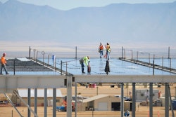 In this Nov. 14, 2017, file photo, construction workers build one of the Facebook data center buildings in Los Lunas, N.M. A powerful regulatory authority in New Mexico decided Tuesday, April 16, 2019, it is requiring the state's largest utility to bill Facebook $39 million for the construction of a new transmission line, a move that the social media giant says could affect its long-term operations in the state.