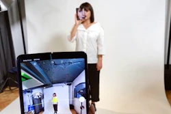 In this April 16, 2019, file photo, a model holds a Samsung Galaxy Fold smart phone to her face, during a media preview event in London. Samsung is pushing back this week's planned public launch of its highly anticipated folding phone after reports that reviewers' phones were breaking. The company had been planning to release the Galaxy Fold on Friday. Instead, it says it will to run more tests and announce a new launch date in the coming weeks.