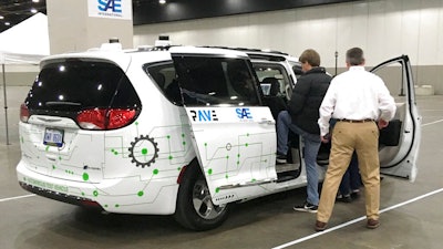 A person gets into a self-driving Chrysler Pacifica Hybrid Friday, April 5, 2019, in Detroit. Hundreds from the general public are signed up for the six-minute journey that leads riders through a course set up inside a Detroit convention center, as part of an effort to clear up misunderstandings and confusion about the technology.