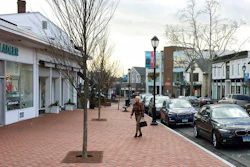 In this Jan. 26, 2017, file photo, a woman walks near shops in downtown Westport, Conn. The boom market in small businesses is showing signs of cooling. The number of small business sales counted by online market BizBuySell.com fell 6.5% during the first quarter from the same period of 2018, following a 6% fourth quarter drop.