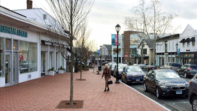 In this Jan. 26, 2017, file photo, a woman walks near shops in downtown Westport, Conn. The boom market in small businesses is showing signs of cooling. The number of small business sales counted by online market BizBuySell.com fell 6.5% during the first quarter from the same period of 2018, following a 6% fourth quarter drop.