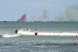 A cloud of orange smoke rises over nearby Cape Canaveral Air Force Station as seen from Cocoa Beach, Fla., Saturday, April 20, 2019. SpaceX reported an anomaly during test firing of their Dragon 2 capsule at their LZ-1 landing site.