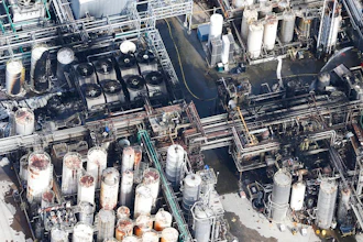This aerial photo shows firefighters spraying water on a fire at the KMCO chemical plant on Tuesday, April 2, 2019 in Crosby, Texas. Authorities say the fire has been contained at the plant near Houston and they have lifted an order that instructed residents within a 1-mile (1.6 kilometers) radius of the facility to stay indoors.