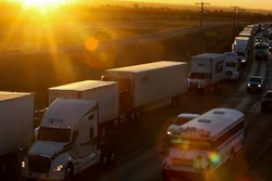 A row of trucks wait to cross the border with the United States in Ciudad Juarez, Mexico. The Trump administration has reassigned so many inspectors from U.S.-Mexico border crossings that it has caused huge traffic backups.