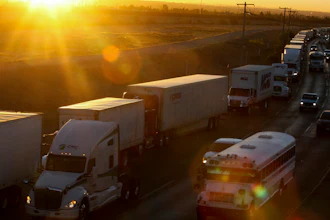 A row of trucks wait to cross the border with the United States in Ciudad Juarez, Mexico. The Trump administration has reassigned so many inspectors from U.S.-Mexico border crossings that it has caused huge traffic backups.
